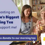 a group of women smiling and holding cups